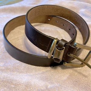 Brown leather belt, some scratches, solid brass buckle.  Measures 33”